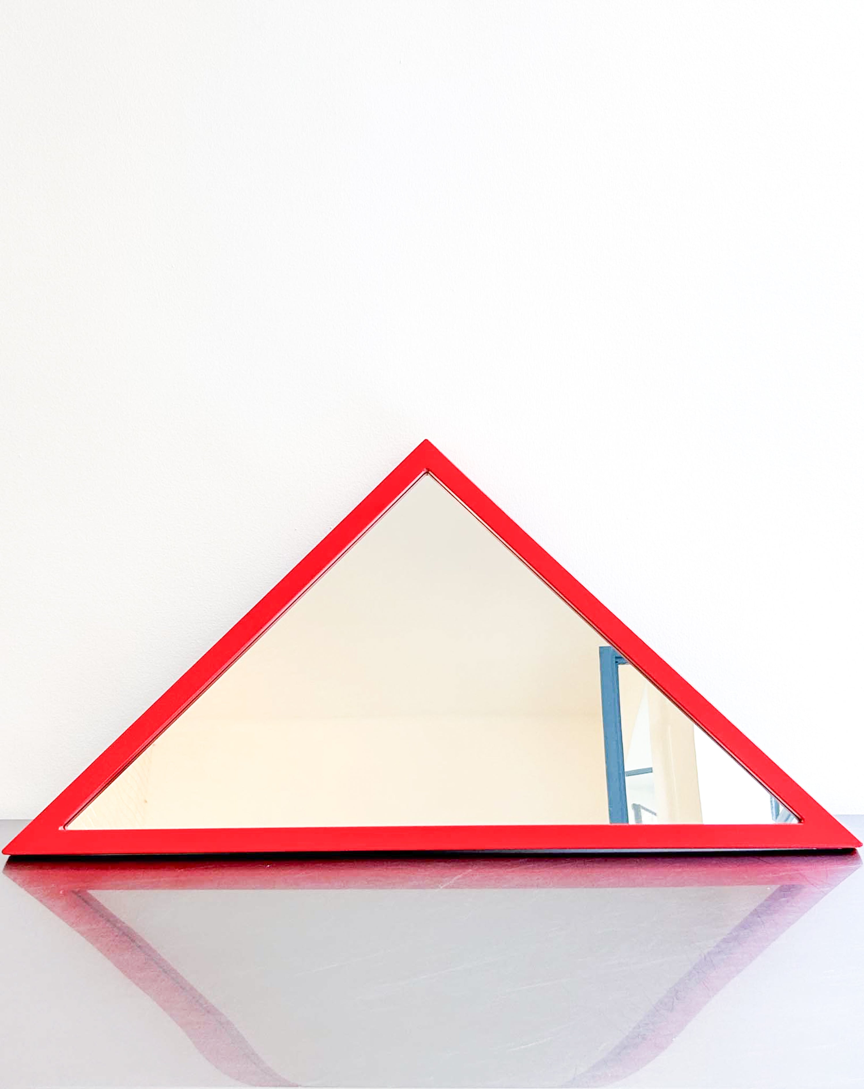 red triangle mirror by Anna Castelli