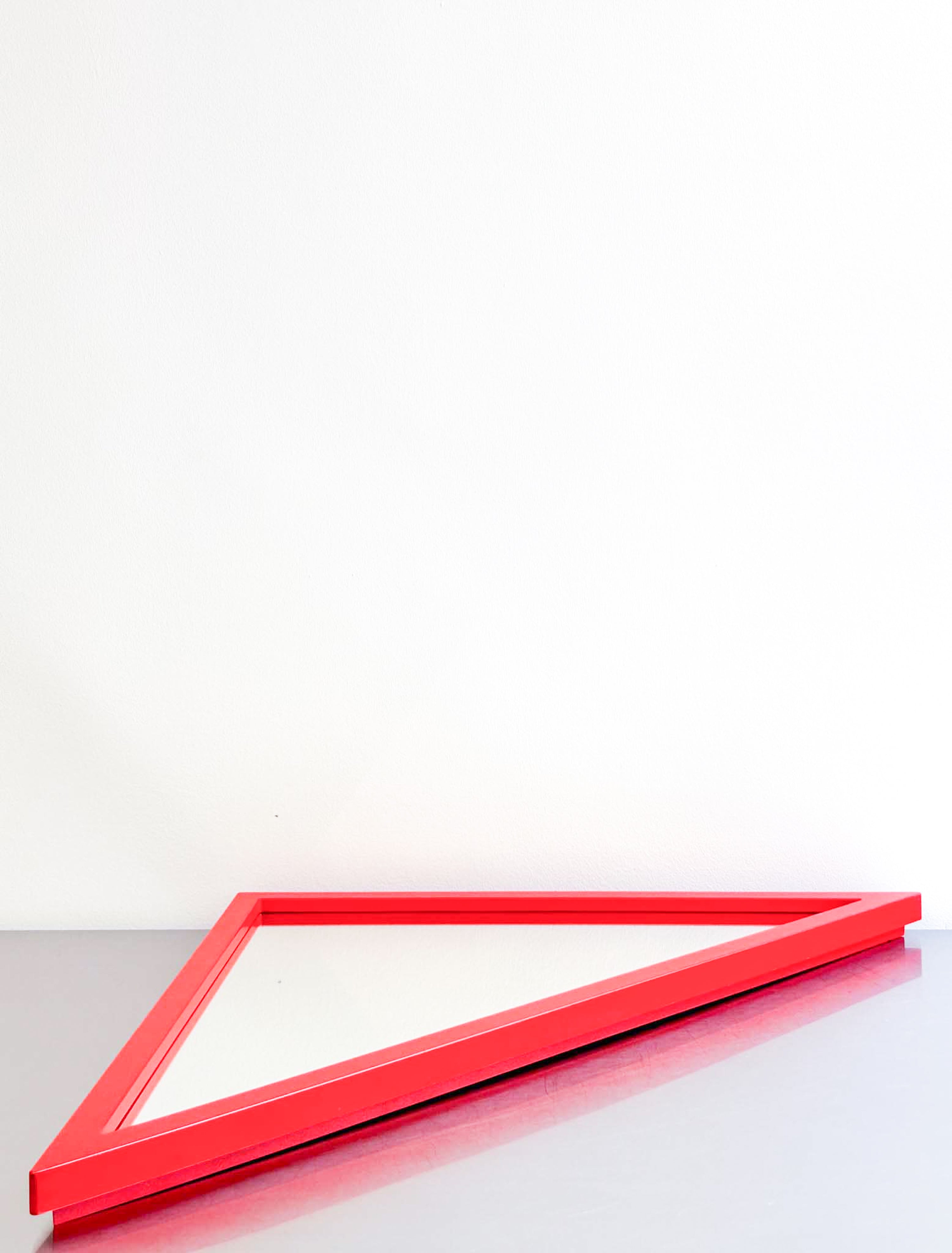 red triangle mirror by Anna Castelli