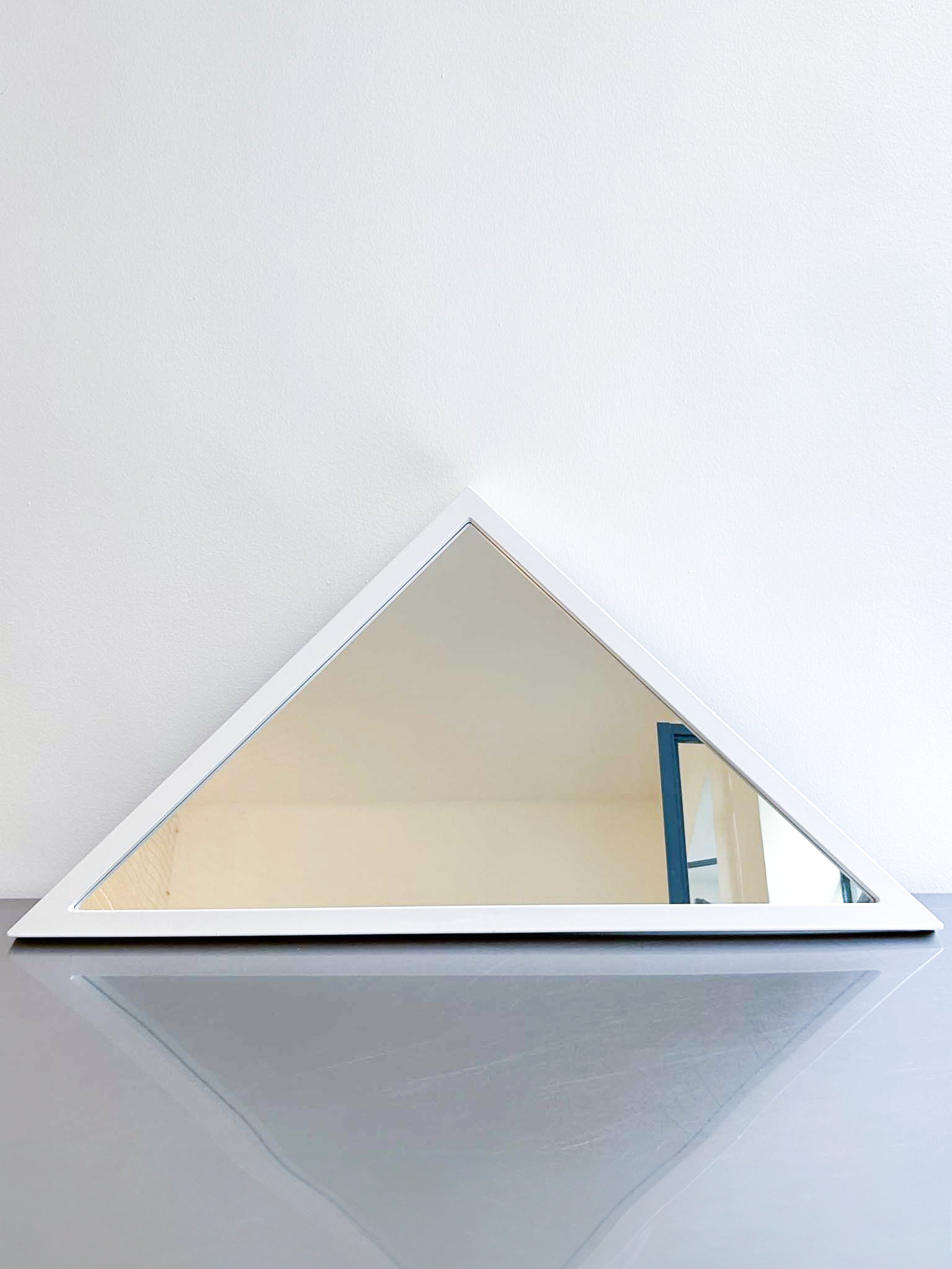 white triangle mirror by Anna Castelli